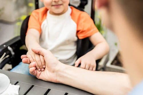 Father holding son's hand