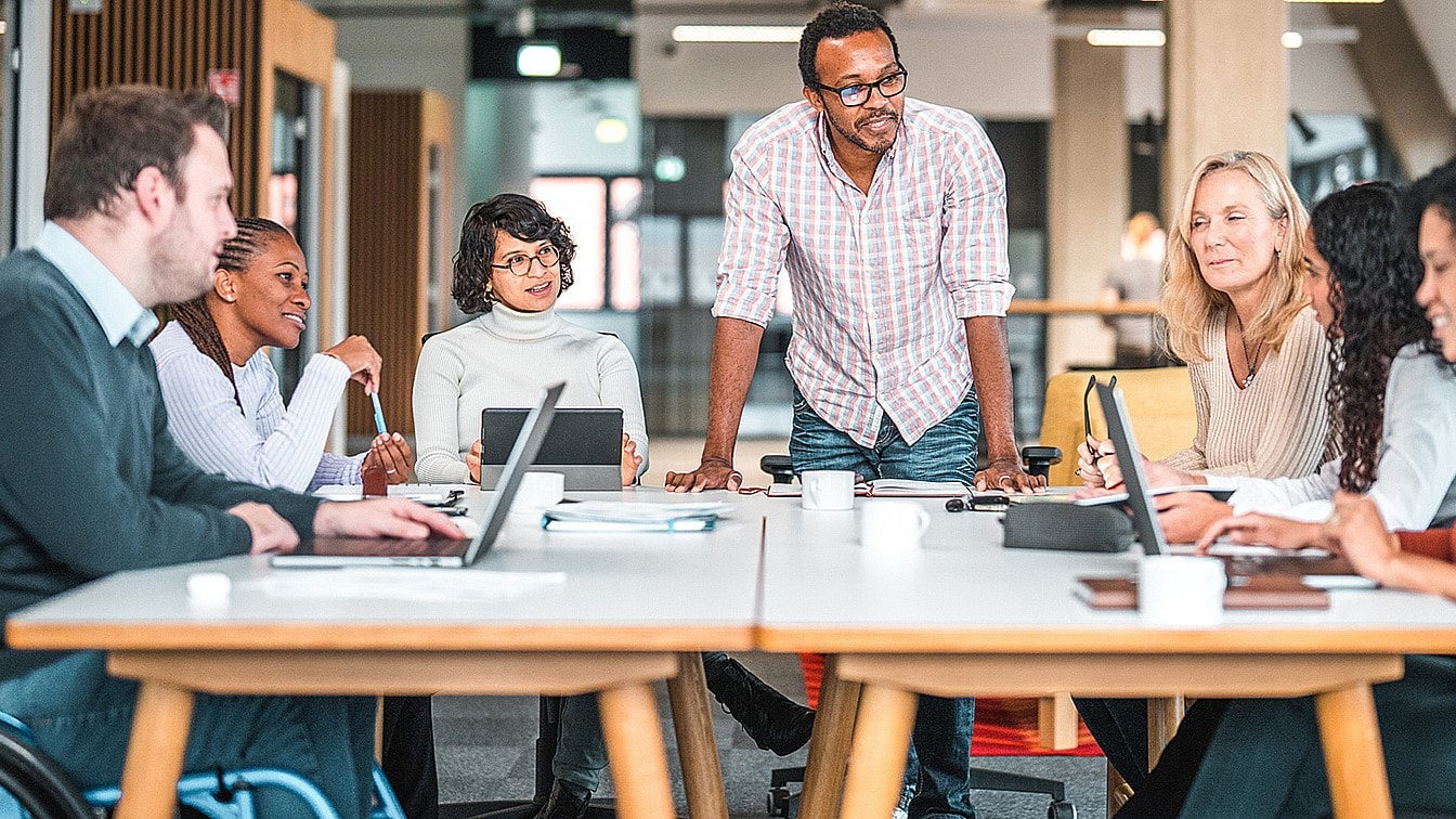 Diverse group of people working at a table.