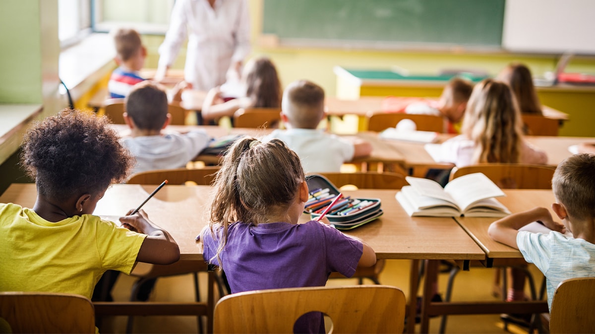 Image of children in a classroom from the back of the room