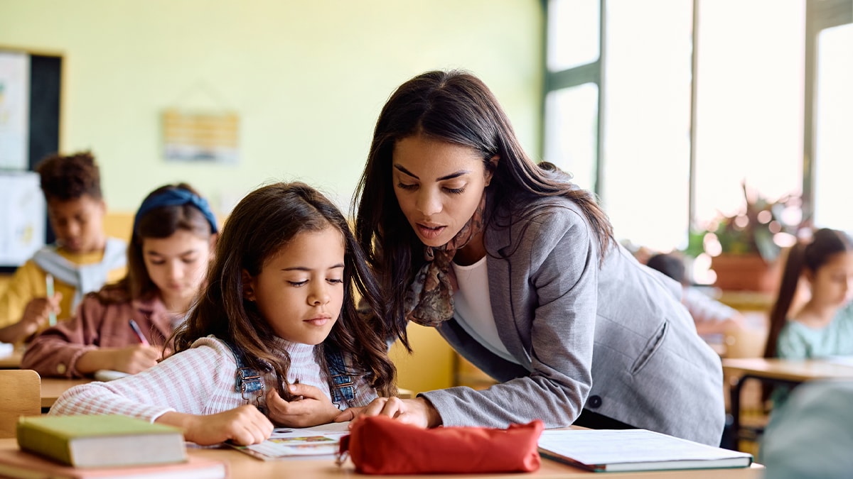 A teacher is helping a student in the classroom