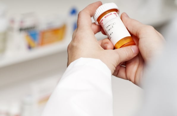 Image of hands holding a prescription bottle