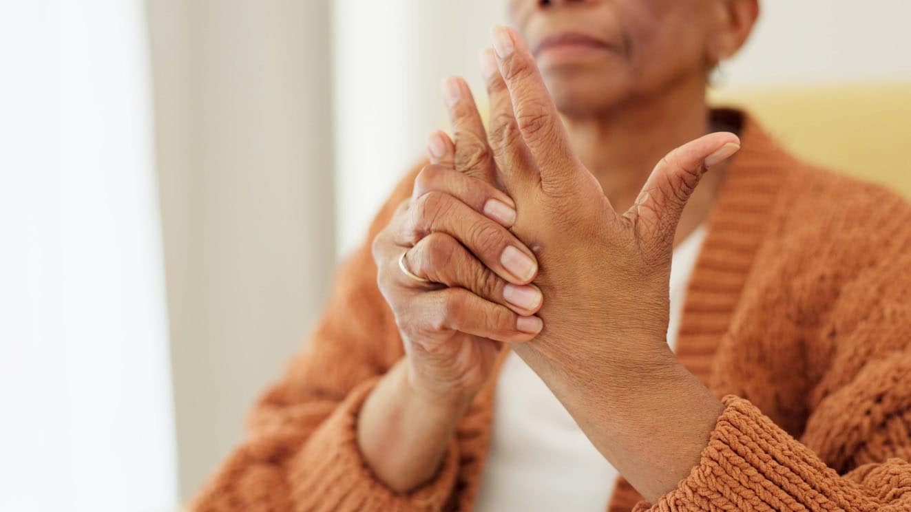 Woman holding hand in pain