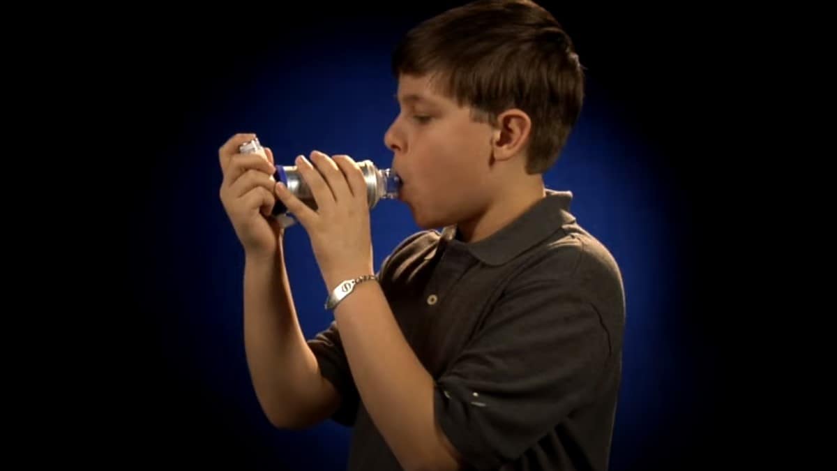 Boy using an asthma inhaler