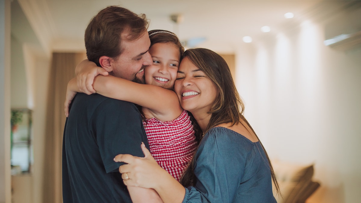 Father and mother hugging their child