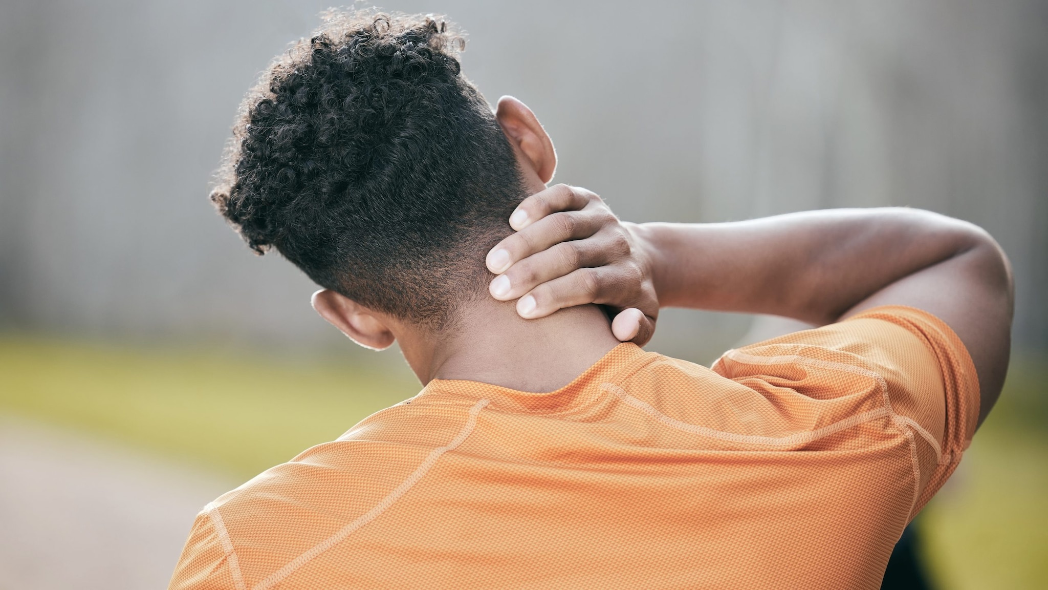 Man rubbing the back of his neck.