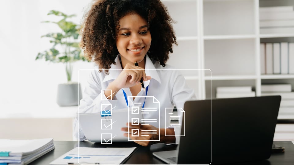 Doctor sitting at a laptop, with a graphic of a survey layered over the photo.