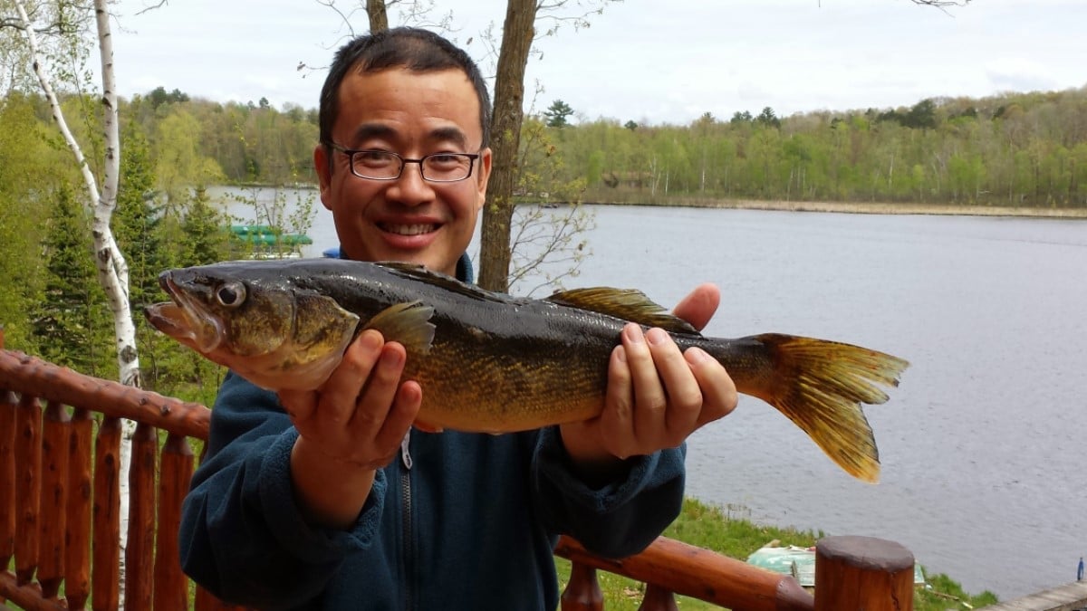 Man holding a fish that he caught