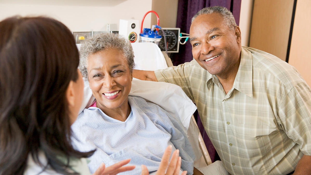 Doctor talking to senior couple