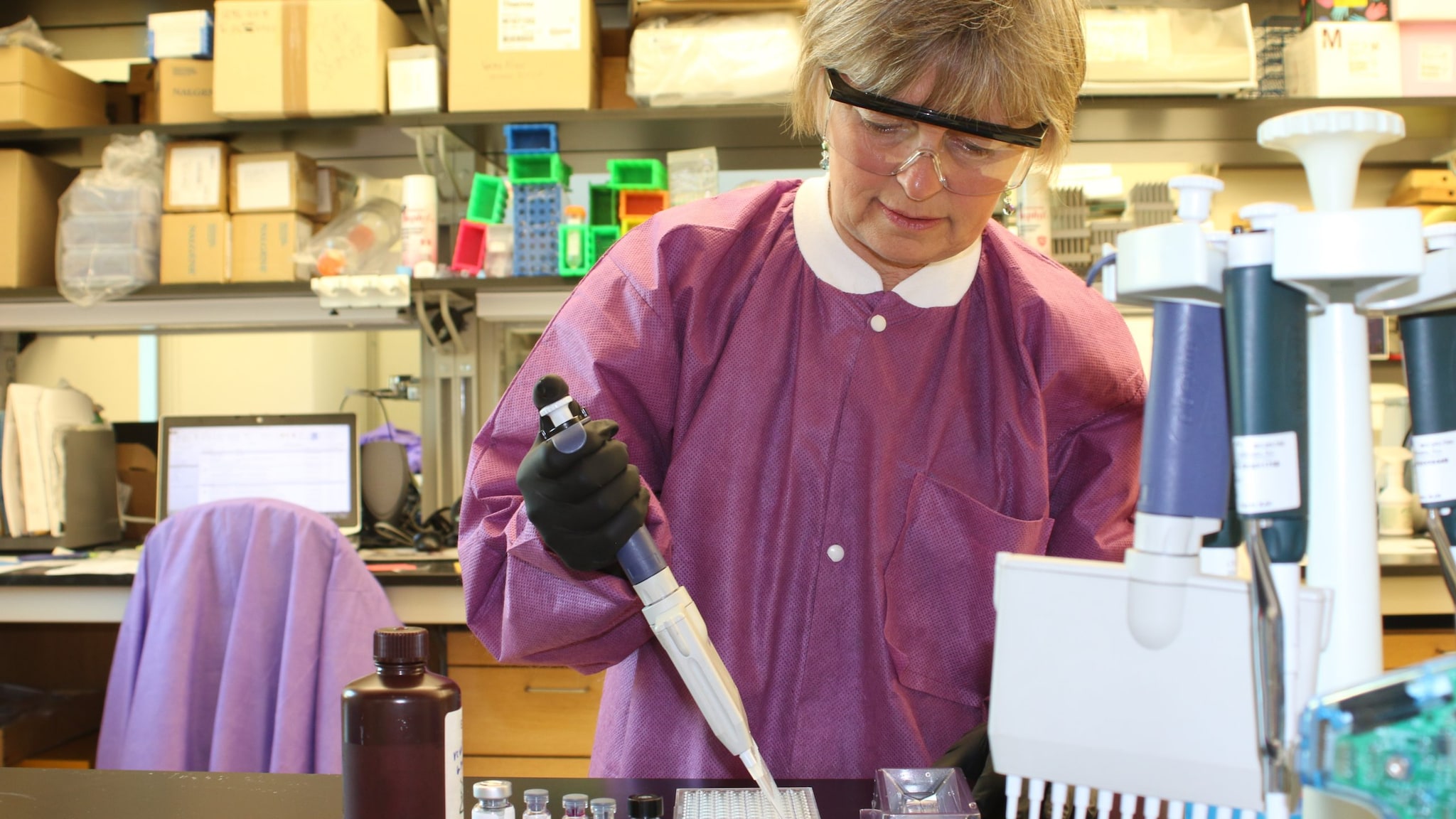 Lab worker holding a pipette