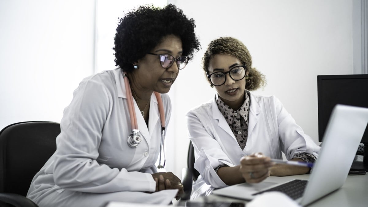 two doctors looking at a computer