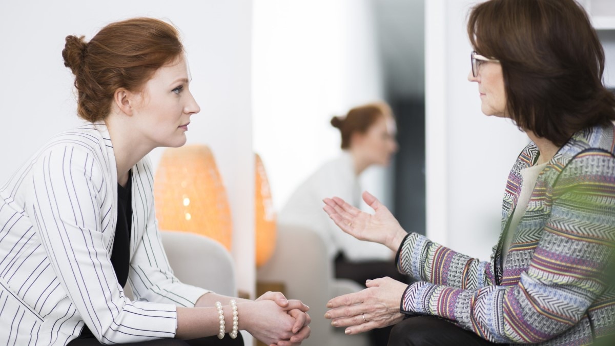 a patient navigator talking to a patient