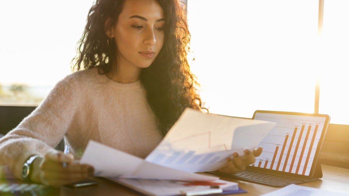 a woman looking at charts and graphs