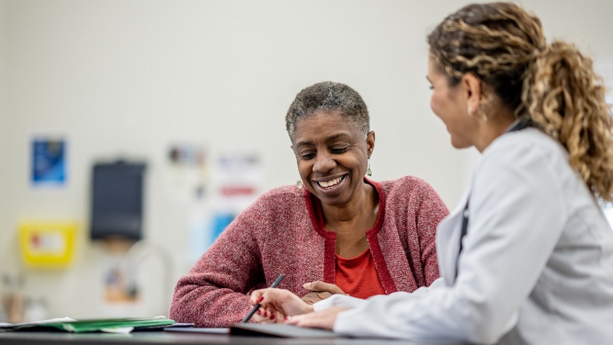 A senior woman talks to her doctor