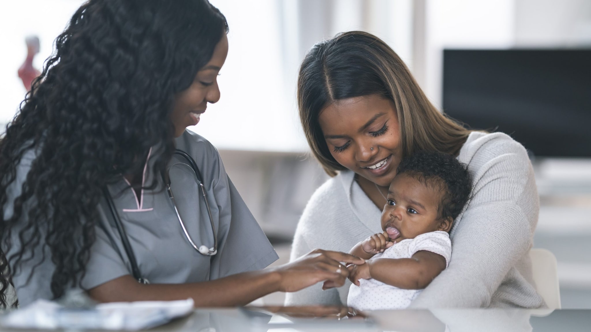 Mom and baby visiting with health care provider