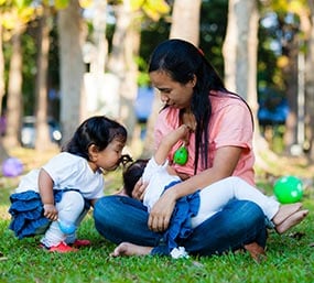 A mother breastfeeding.