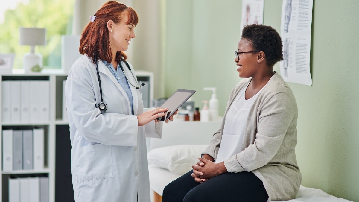 a doctor talking to a young woman patient