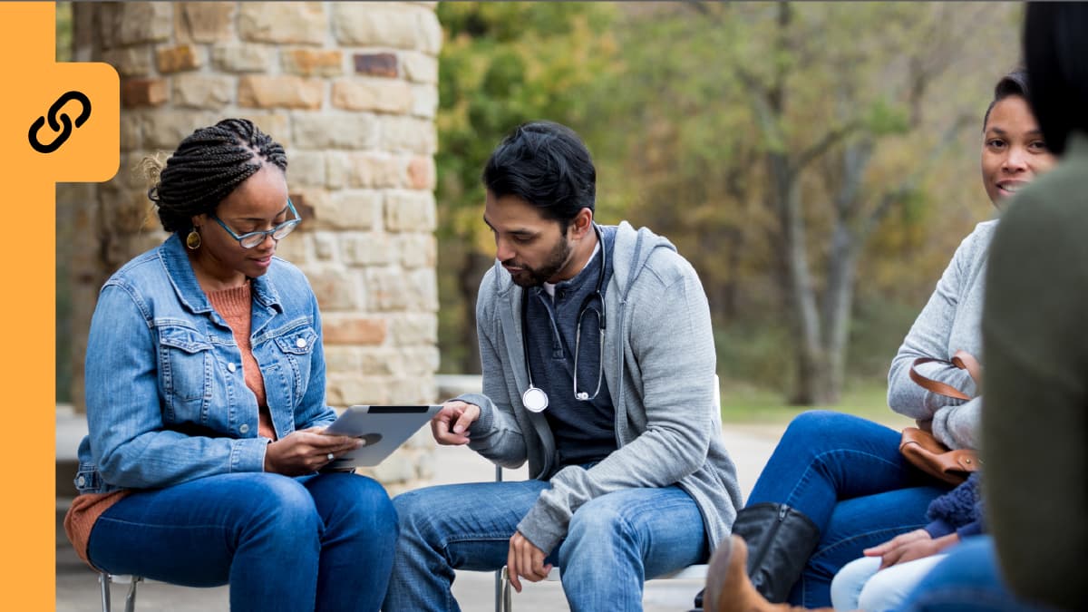 A doctor discussing results with his patients at a picnic area.