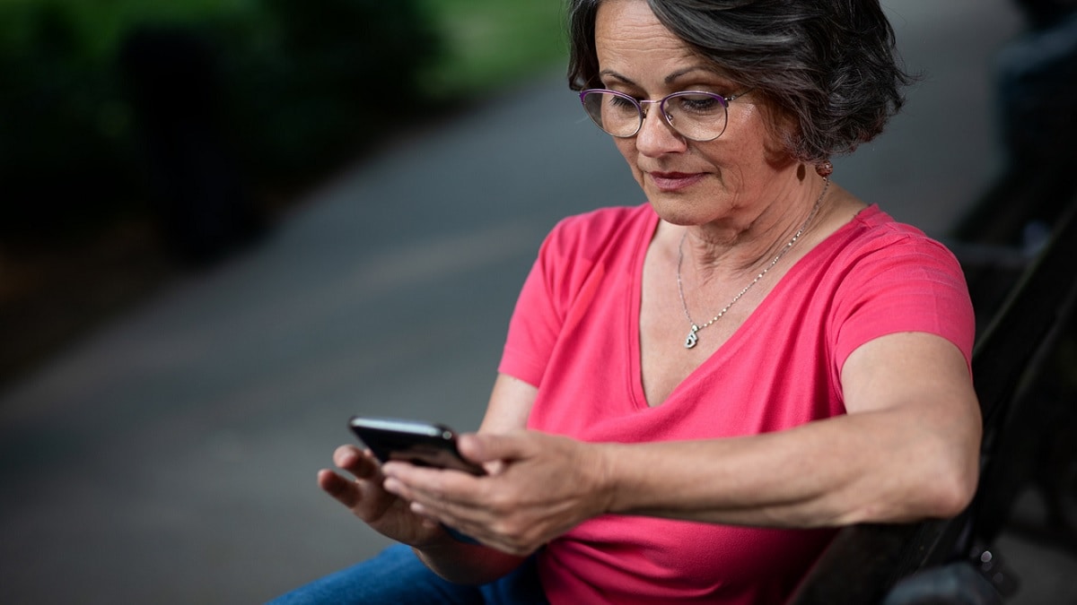 A woman reading a text message on her cell phone