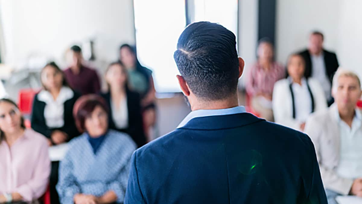 Adult businessman doing a presentation at office meeting