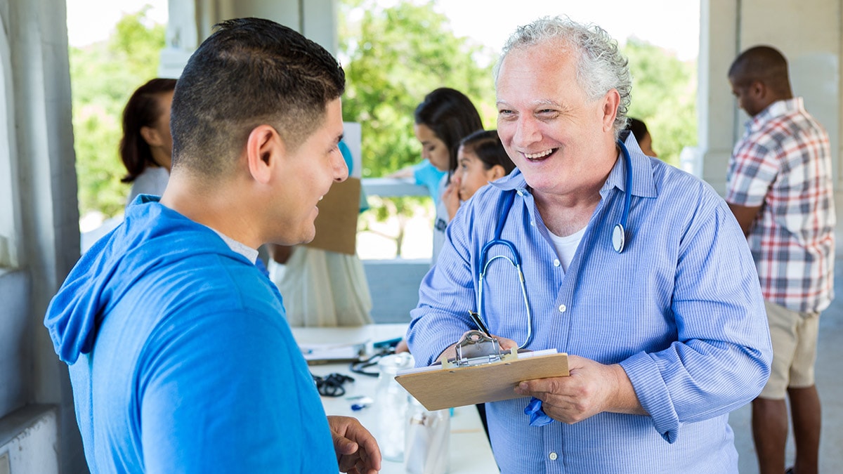 Smiling doctor speaking with an employee in the workplace.