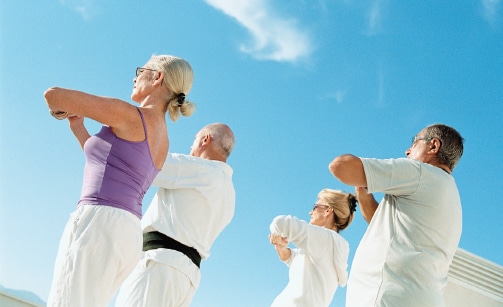 Photo of older adults exercising outside.