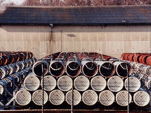 Bulk containers of chemical agent stored outside.