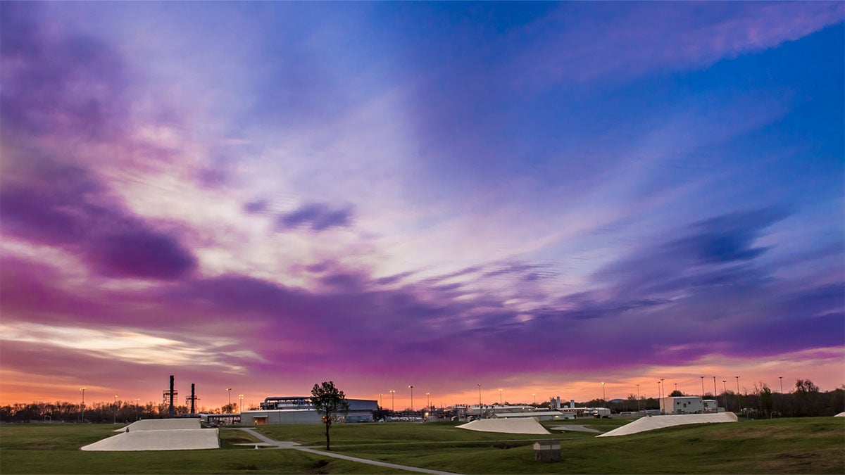 A photo of an industrial facility at twilight.