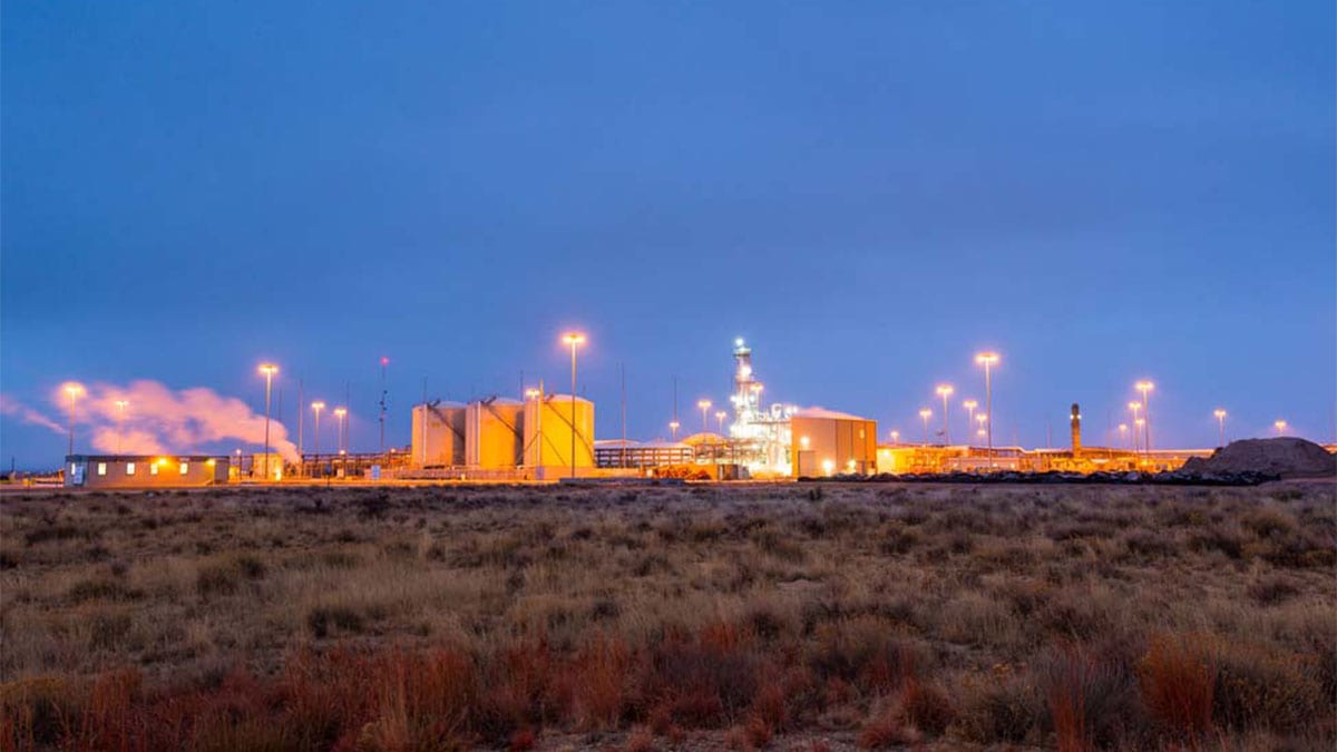 A photo of an industrial facility at twilight.