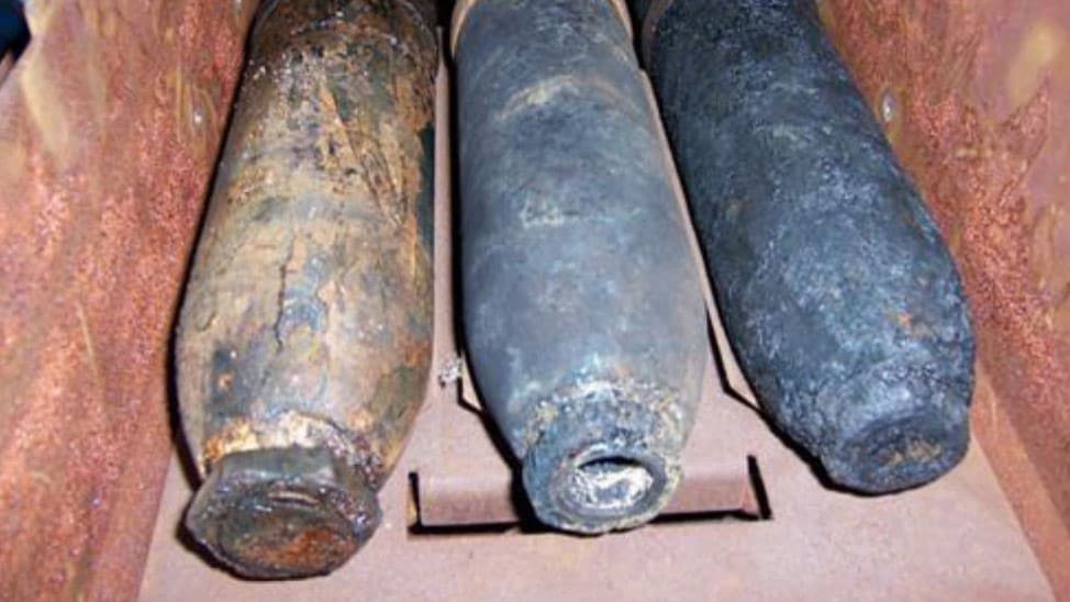 Three weapons in a box that were recovered from the ocean