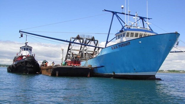 A fishing and a tugboat vessel docked.