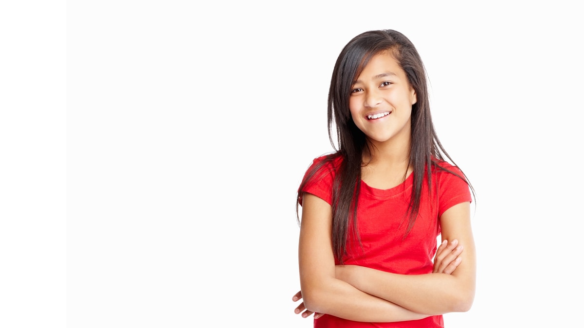 young girl smiling and crossing her arms