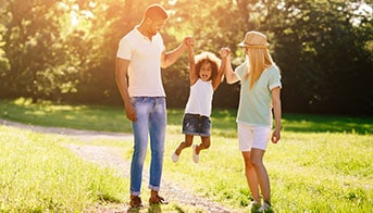 Mother and Father lifting their daughter into the air