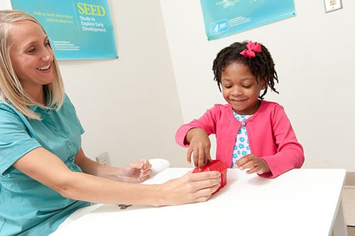 Young girl testing woth blocks