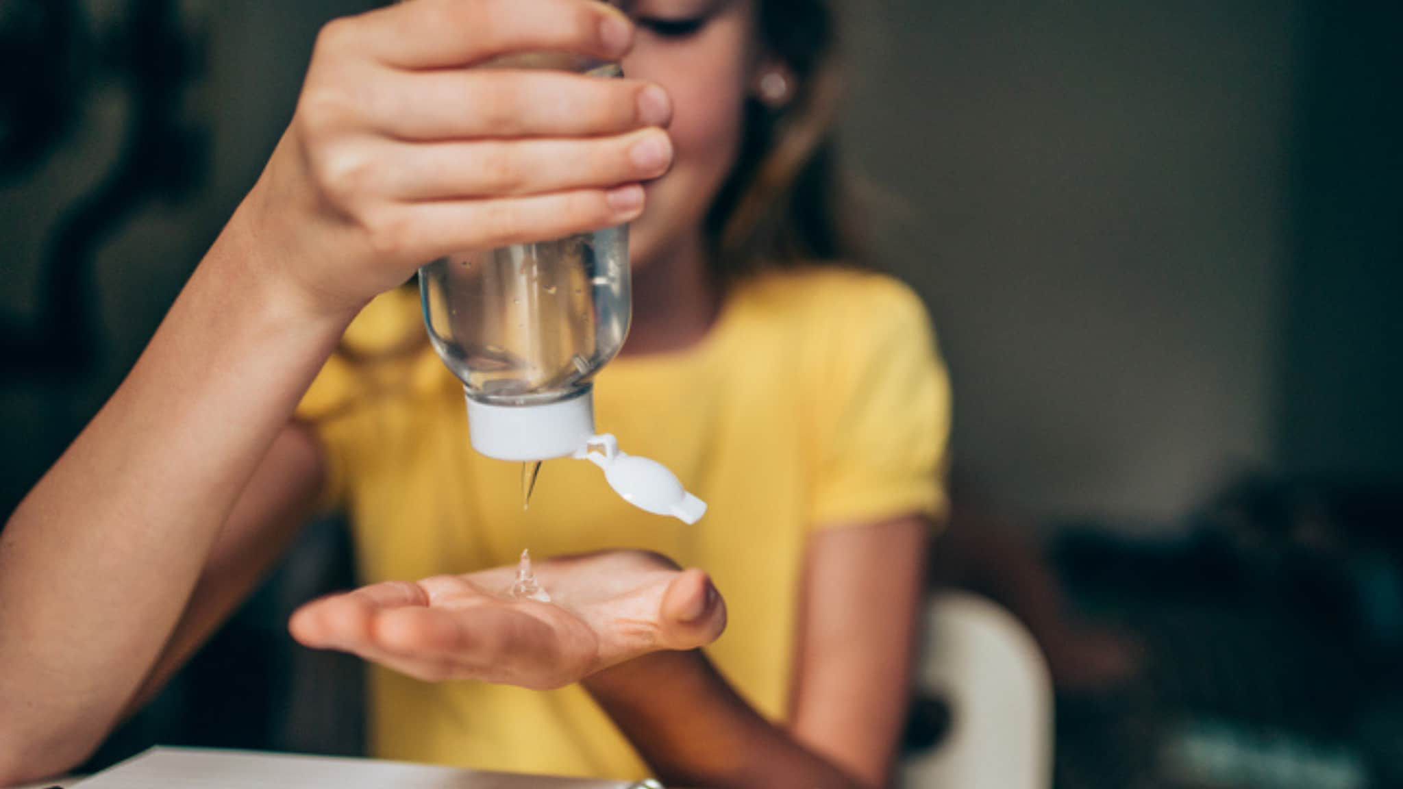 Girl using hand sanitizer