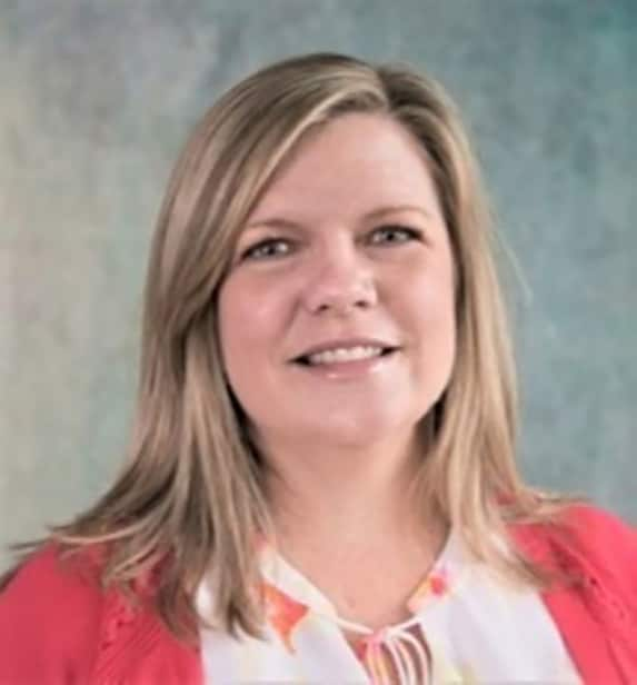 Heather Stang's headshot. She has shoulder length blonde hair and is wearing a peach-colored sweater with a white shirt.