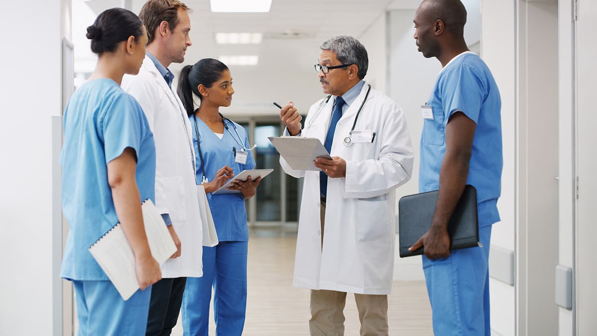 a doctor talking to clinic staff members