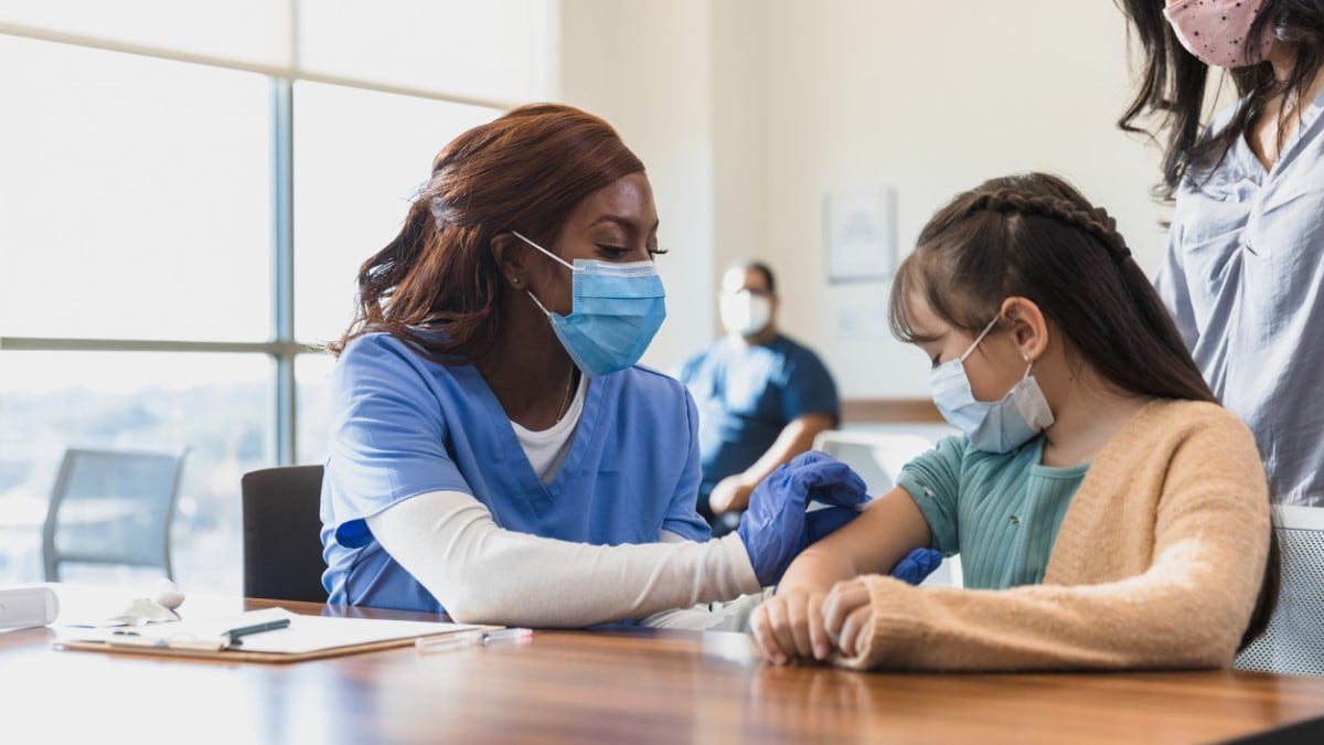 Photo of a nurse giving an HPV shot to a girl