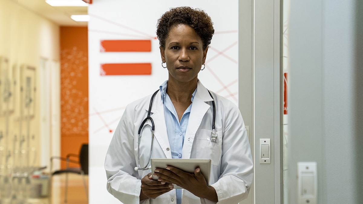 A female doctor with a stethoscope around her neck.