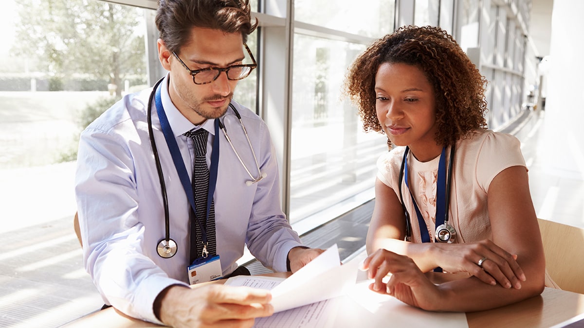 Two medical professionals reviewing some test results.