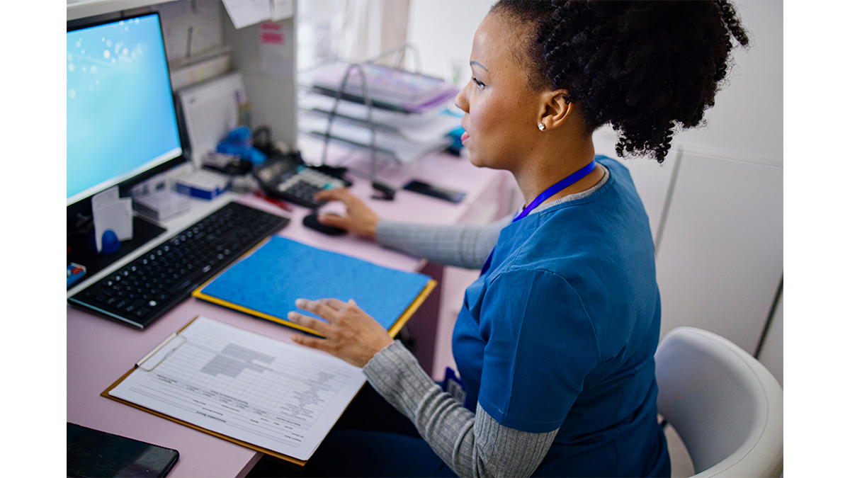 Healthcare provider working on a computer.