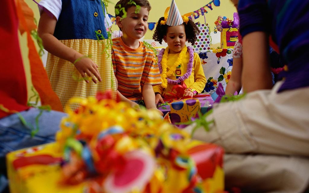 Kids opening birthday presents.