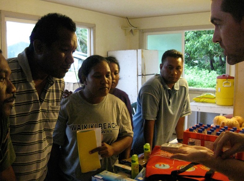 CDC epidemiologist Dr. Tyler Sharp teaches health workers in the Republic of the Marshall Islands to use a rapid dengue diagnostic test.