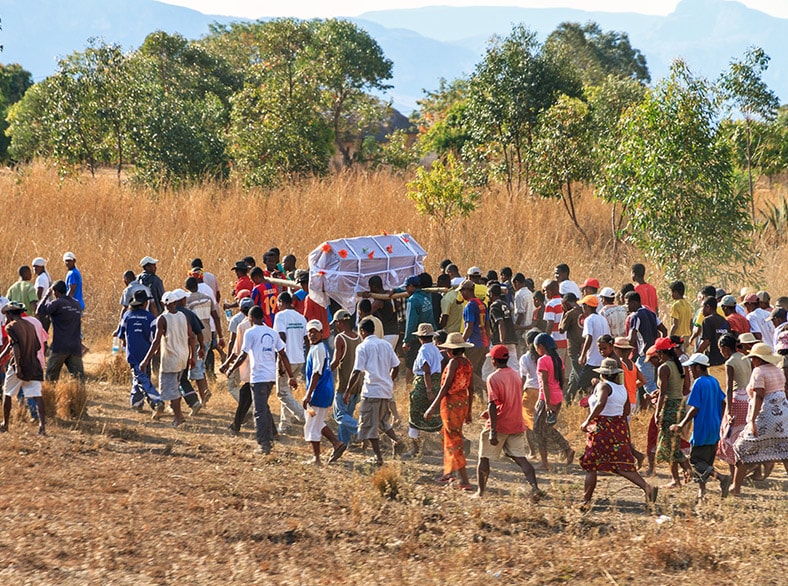 A traditional African burial - lots of people attending the funeral of a person that has died from Ebola.