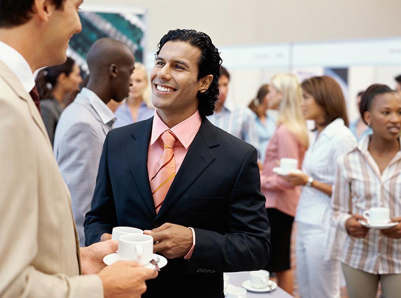 Conference attendees talking during the Welcome Party.