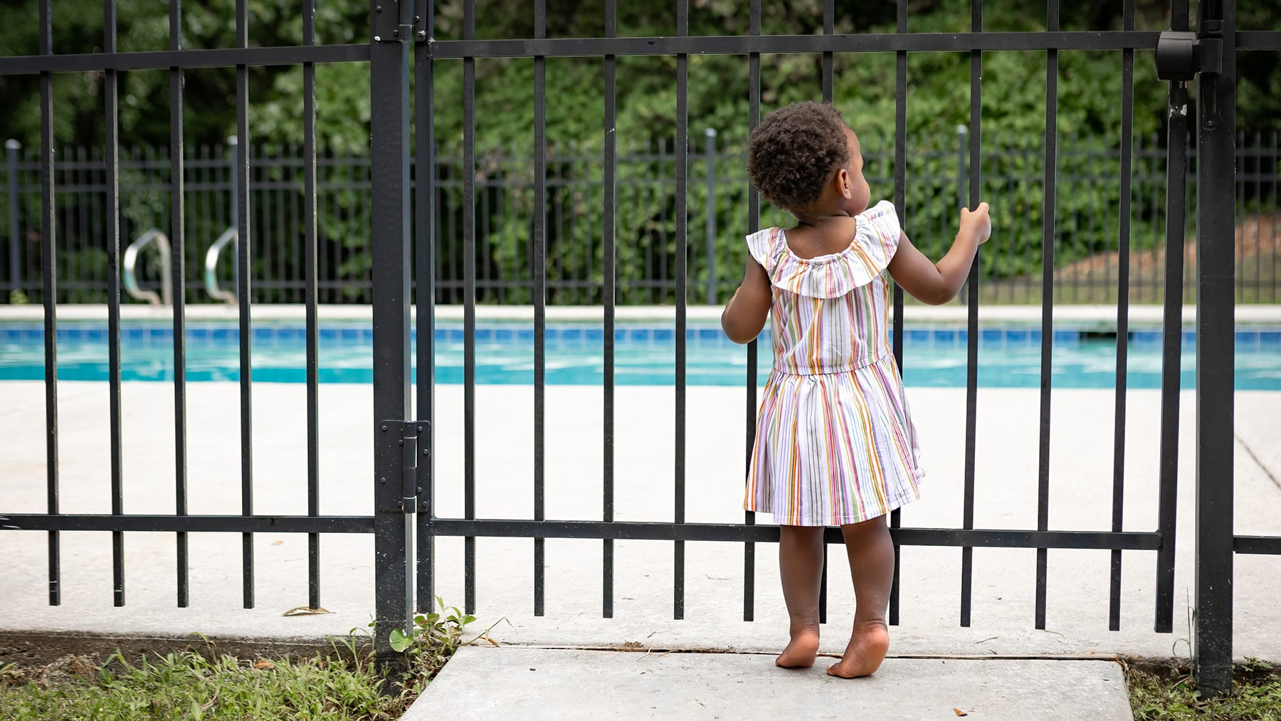 Toddler at pool secure pool fence