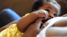 image of a baby looking up at caregiver.