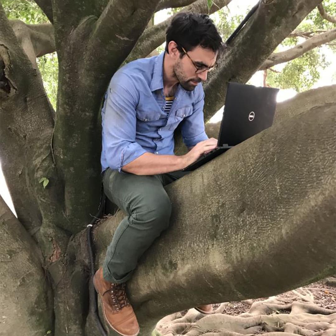 EIS officer sits in a tree in Goma, Democratic Republic of Congo, working on the Ebola response in 2019.