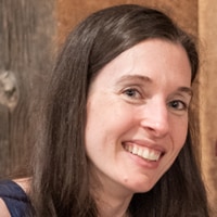 White woman with dark hair smiling