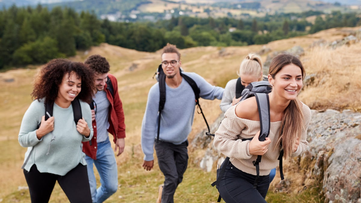 Group of young adults backpacking on a mountain