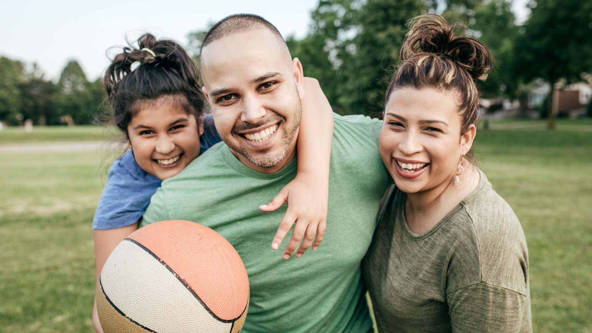 Family playing basketball outside